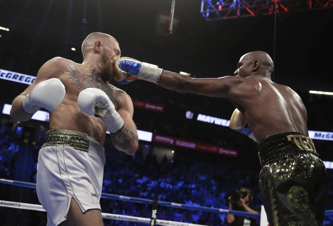 Floyd Mayweather Jr. jabs Conor McGregor in a super welterweight boxing match Saturday, Aug. 26, 2017, in Las Vegas. (AP)