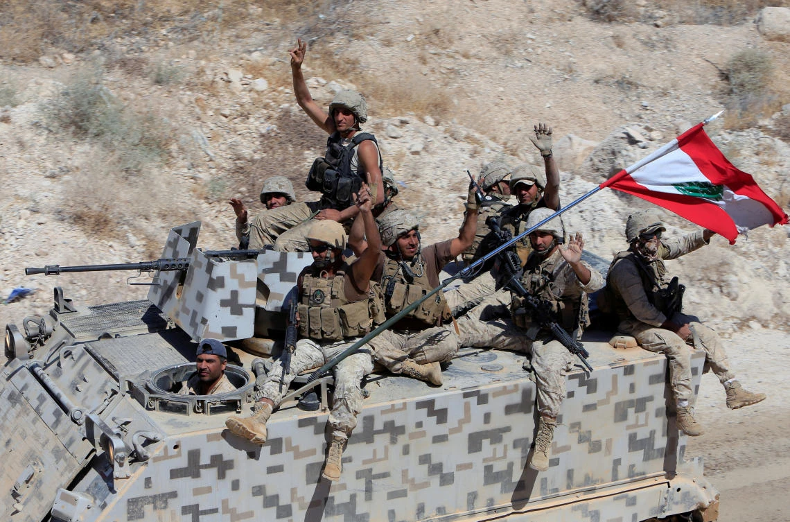 FILE PHOTO: Lebanese army soldiers gesture as they sit on their military vehicles in the town of Ras Baalbek, Lebanon August 21, 2017. (REUTERS)