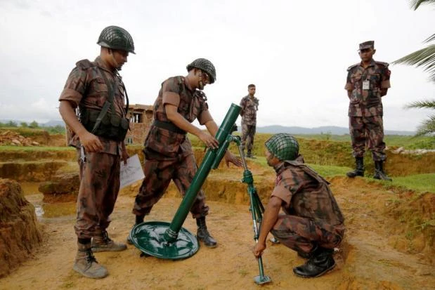 Members of Border Guard Bangladesh (BGB) prepare a mortar as a part of their defence after heavy gunshots were heard on the Myannmar side in Cox’s Bazar, Bangladesh, on Saturday. (Reuters)