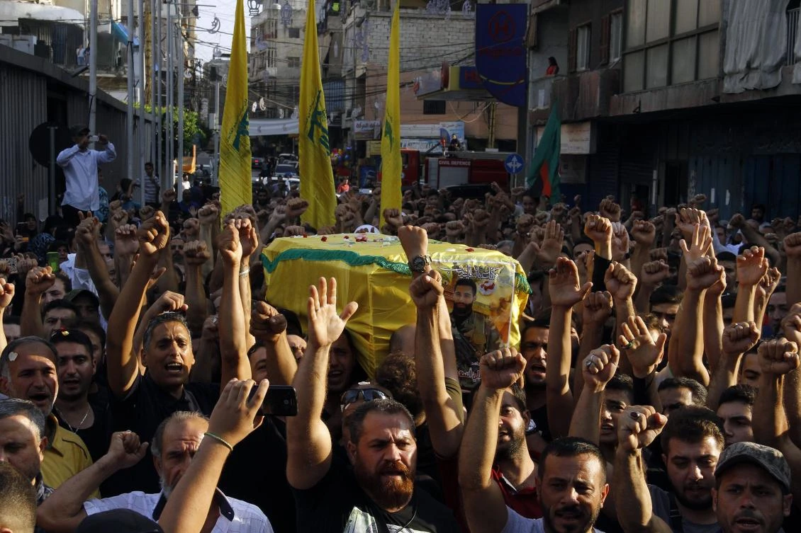 Mourners carry the coffin of Mohammed Haj Hussein, a fighter from Lebanon's Shiite Hezbollah movement who was killed in clashes against militant groups in a mountainous area on the eastern border with war-ravaged Syria, during his funeral in Beirut's southern suburb of Ghobayri on August 24, 2017. (AFP)