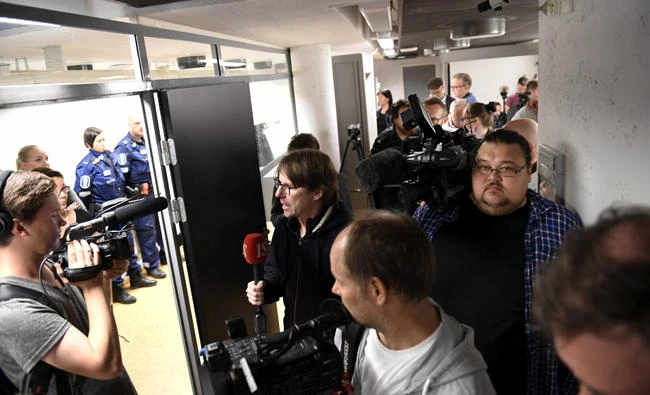 Press and and police are pictured before the initial remand hearing on August 19 of Abderrahman Mechkah (lying in a hospital bed, attending the court session via video), an 18-year-old Moroccan man suspected of killing two people and attempting to kill eight others with terrorist intent in Turku, Finland. (Lehtikuva /Martti Kainulainen via REUTERS)