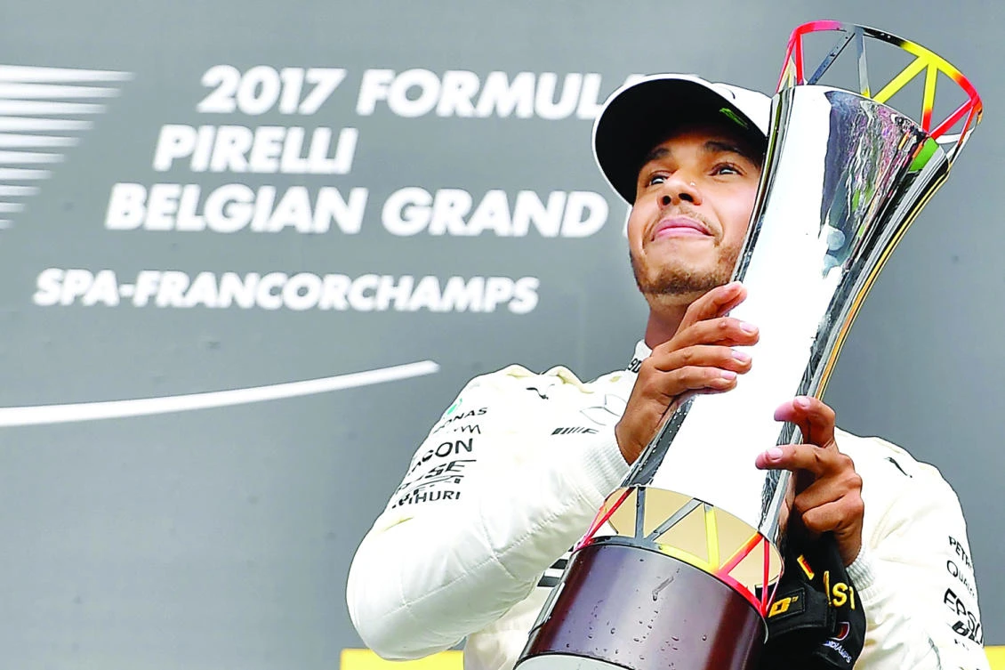 Winner Mercedes' British driver Lewis Hamilton celebrates on the podium after the Belgian Formula One Grand Prix at the Spa-Francorchamps circuit in Spa on Sunday. (AFP)