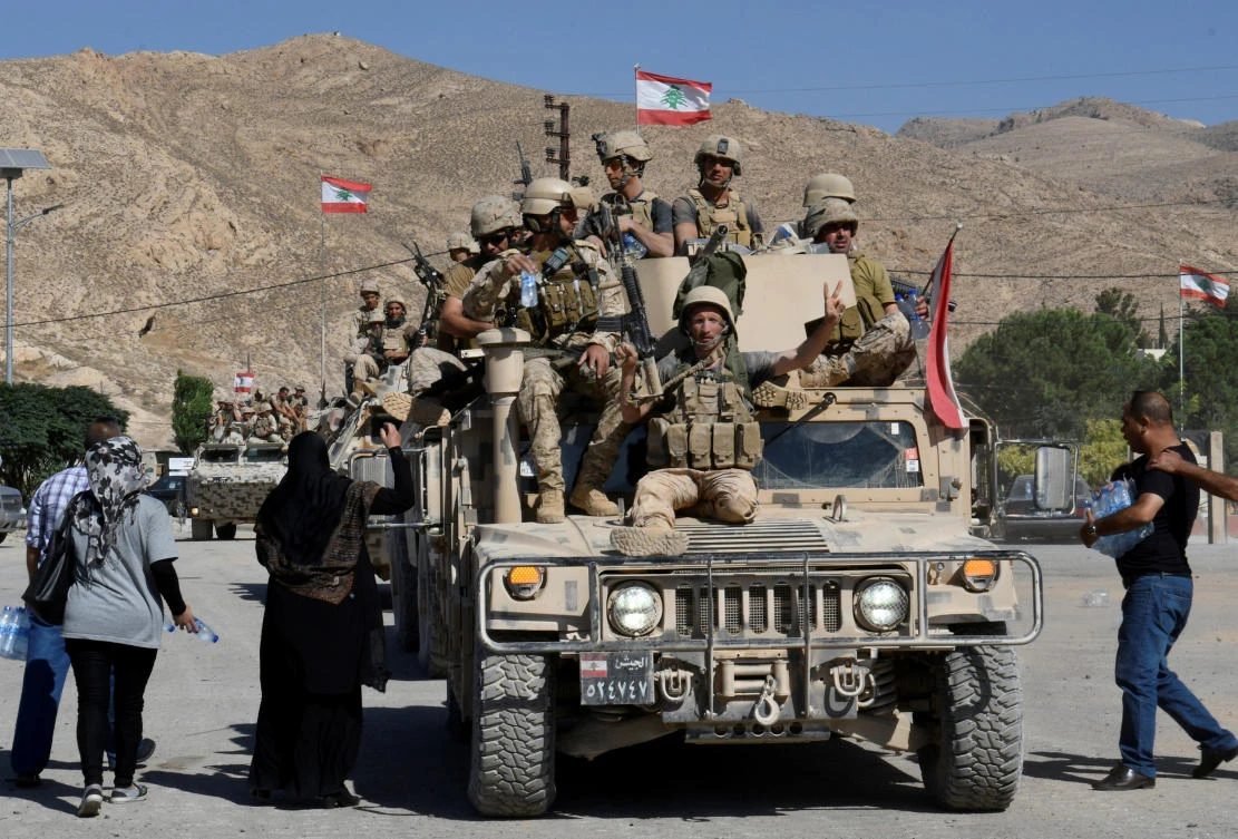 Lebanese solders arrive on Sunday near the town of Ras Baalbek, Lebanon. (Reuters)