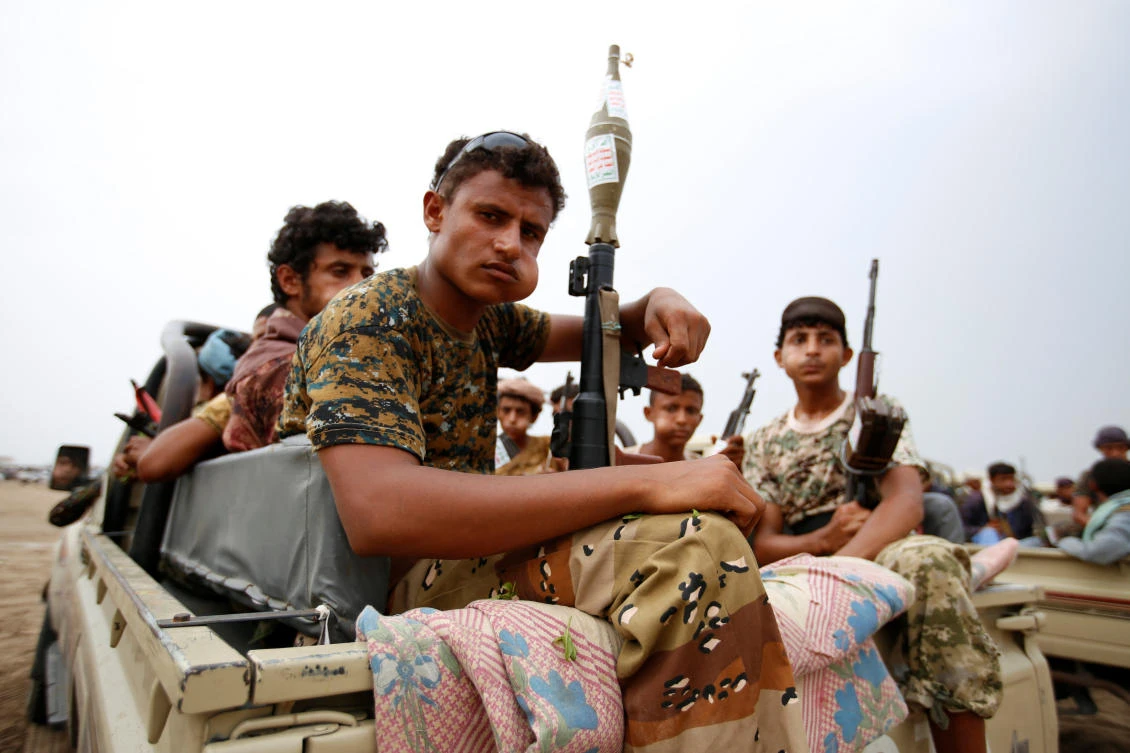 Houthi militias ride on the back of a truck during a recent parade in the Red Sea port city of Hodaida, Yemen. (Reuters)