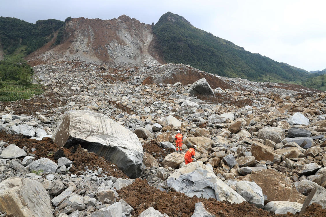 Rescue workers search for survivors at the site of a landslide that occurred in Nayong county, Guizhou province, China, on August 28, 2017. (Stringer via Reuters)