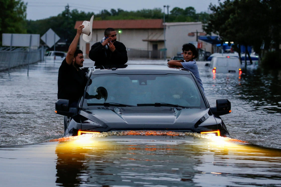 Residents use a truck to navigate through flood waters from Tropical Storm Harvey in Houston, Texas, US August 27, 2017. (REUTERS)