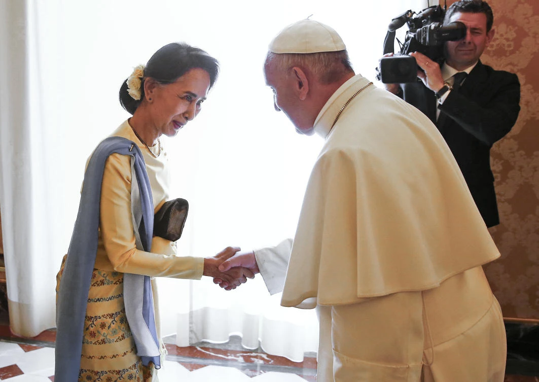 In this file photo, Myanmar leader Aung San Suu Kyi, left, is welcomed by Pope Francis at the Vatican, on May 4, 2017. (Pool Photo via AP)