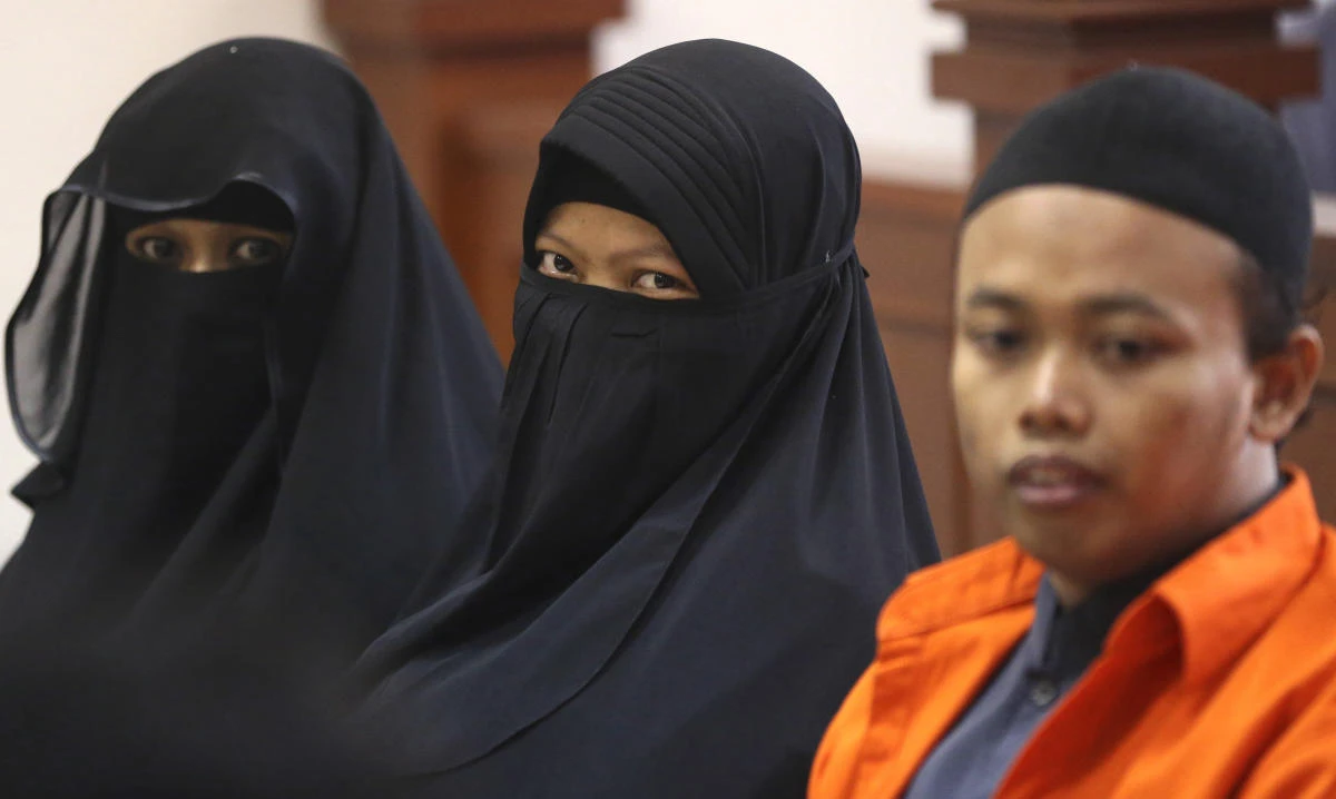 Indonesian militant Dian Yulia Novi, center, is flanked by her husband Nur Solihin, right, and her recruiter Tutin as they sit on the defendant’s bench during their trial hearing at East Jakarta District Court in Jakarta, Indonesia, on August 23, 2017. (AP)