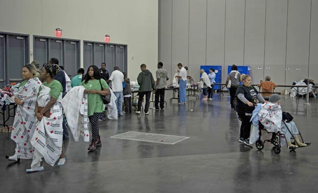 Flood victims are seen at a shelter in the George R. Brown Convention Center during the aftermath of Hurricane Harvey on August 28, 2017 in Houston, Texas. (AFP / Brendan Smialowski)