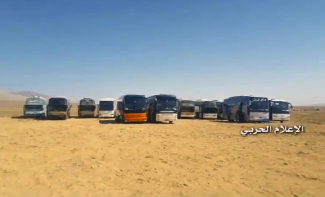 This frame grab from video released on Monday, Aug 28, 2017 and provided by the government-controlled Syrian Central Military Media, shows buses gathering before a planned evacuation of Daesh militants, in the mountainous region of Qalamoun, Syria. (Syrian Central Military Media, via AP)