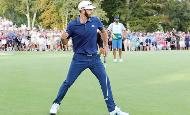 Dustin Johnson reacts after hitting a par putt on the 18th hole to force a playoff with Jordan Spieth (not pictured) during the final round of The Northern Trust golf tournament at Glen Oaks Club on Sunday. (USA TODAY Sports)