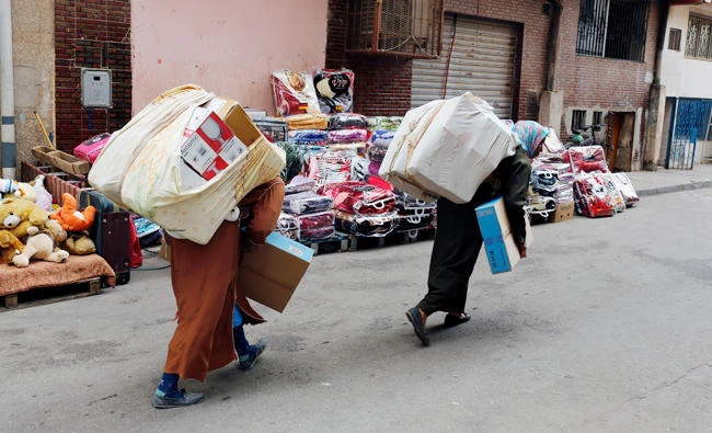 Moroccans women carry goods after crossing the border from Spain's North African enclave of Melilla into Moroccan settlement of Beni Ansar in Beni Ansar, Morocco on July 18, 2017. (Reuters)