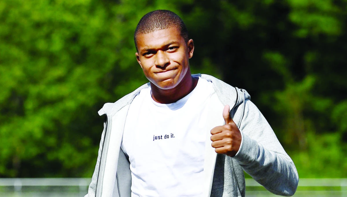 France’s forward Kylian M’Bappe gives the thumbs-up as he arrives at the French national football team training base in Clairefontaine on Monday as part of the team’s preparation for the FIFA World Cup 2018 qualifying football match against Netherlands and Luxembourg. (AFP)