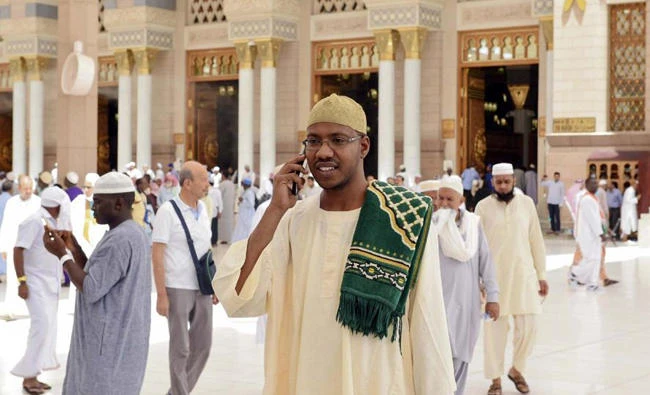 A pilgrim in Madinah makes a phone call to loved ones. (SPA)