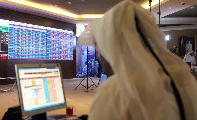 This file photo taken on July 31, 2017 shows A Qatari trader following the stock market at the Qatari stock exchange in Doha. (AFP)