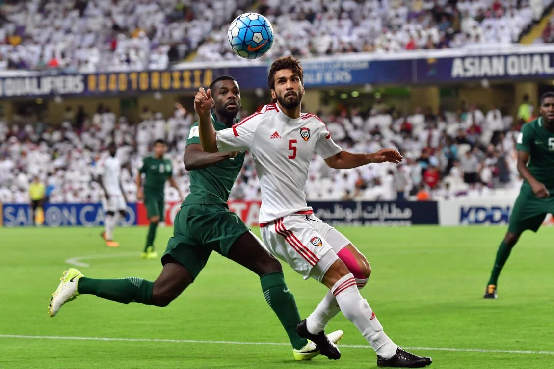 UAE's midfielder Tareq Ahmed (R) vies for the ball with Saudi's defender Mansoor Al-Harbi (L) during the 2018 FIFA World Cup qualifier football match between UAE and Saudi Arabia at the Hazza Bin Zayed Stadium in Al-Ain on August 29, 2017. / AFP / GIUSEPPE CACACE
