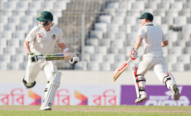 Australian cricket team captain Steve Smith, left, and his teammate David Warner run between the wickets during the third day of the first Test cricket match against Bangladesh in Dhaka Tuesday. (AP)