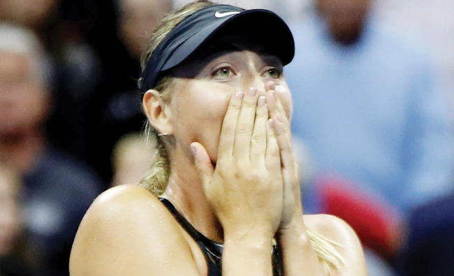 Maria Sharapova of Russia reacts after beating Simona Halep of Romania during their first round match Monday. (Reuters)