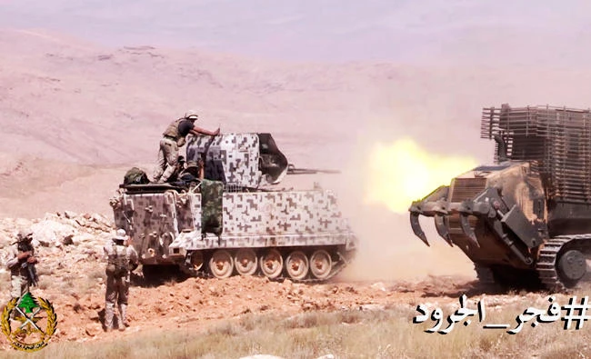This frame grab from video provided by the Lebanese Army official website, shows army soldiers firing towards Islamic State militant positions, on the outskirts of Ras Baalbek, northeast Lebanon, on Sunday. (AP)