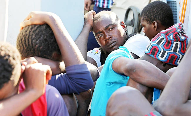 Migrants in a boat arrive at a naval base after they were rescued by Libyan coastguard, in Tripoli, Libya on Tuesday. (Reuters)
