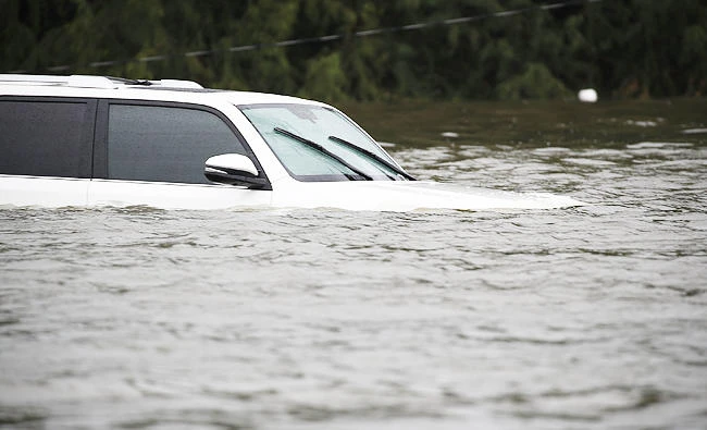 A SUV is seen submerged on the street after the area was inundated with flooding from Hurricane Harvey on Tuesday in Friendswood, Texas. (AFP)