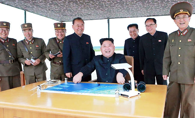 This photo from North Korea's official Korean Central News Agency (KCNA) taken on Tuesday and released on Wednesday shows North Korean leader Kim Jong-Un (C) watching the launch of an intermediate-range strategic ballistic rocket Hwasong-12 in Pyongyang. (AFP)
