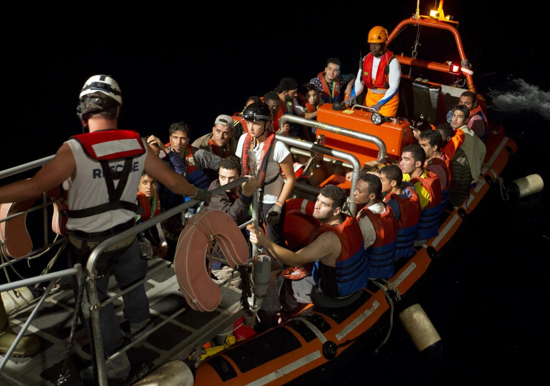 Migrants are transferred from their wooden boat to the Aquarius rescue vessel of SOS Mediterranee and MSF (Doctors Without Borders) NGOs, in the Mediterranean Sea, some 40 Nautical Miles (46 miles, 74 kilometers) north of Libyan coast, on August 30, 2017. (AP)