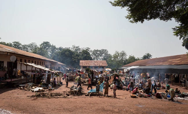 People walk inside the displaced muslims refugee camp of the Catholic minor seminary in Bangassou, south-eastern Central African Republic, some 470 km east of the capital Bangui on August 14, 2017. (AFP)