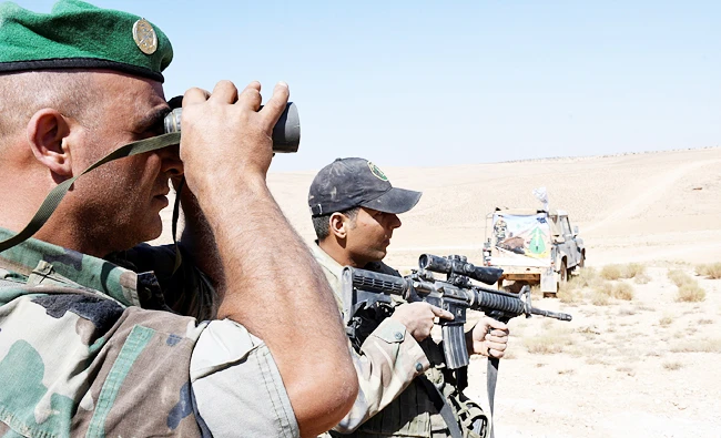 A Lebanese Army soldier looks through binoculars in Ras Baalbek, Lebanon, in this August 28, 2017 photo. (REUTERS)