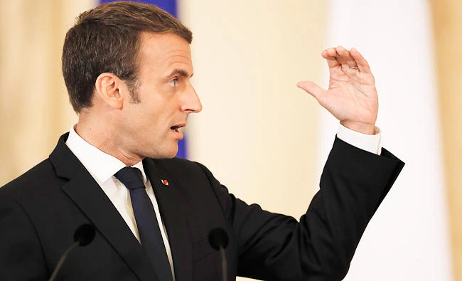 French President Emmanuel Macron gestures during a joint press conference with Romanian counterpart Klaus Iohannis, in Bucharest, Romania, on Thursday. (AP)