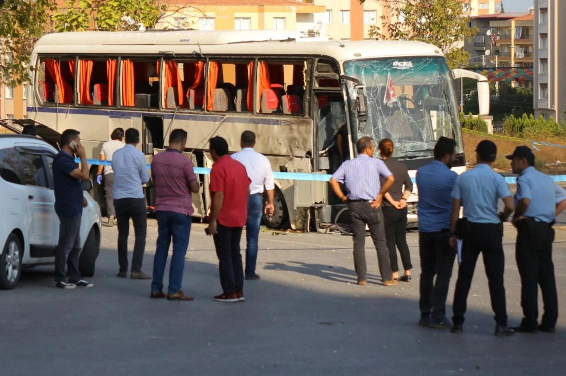 Plainclothes police officers stand after an explosion hit a shuttle bus carrying prison guards in Izmir, Turkey, on August 31, 2017.