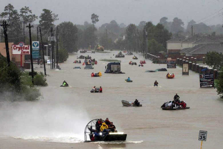 Residents use boats to evacuate flood waters from Tropical Storm Harvey along Tidwell Road east Houston. (Reuters)