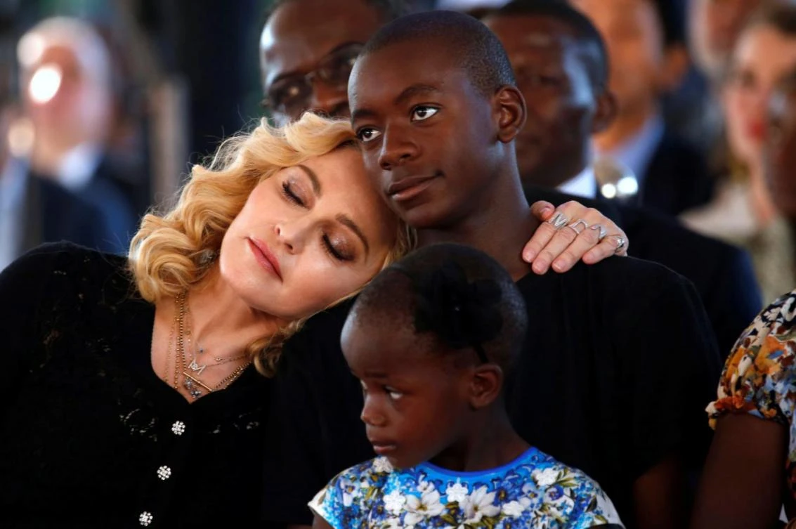 US singer Madonna embraces her adopted son, David Banda ahead of the opening of the Mercy James hospital in Blantyre, Malawi, on July 11, 2017. (File photo by Reuters)