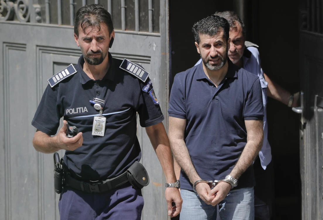 Tavan Resit, a Turkish businessman, walks handcuffed after asking a Romanian court to free him from arrest, in Bucharest, Romania, on Thursday, August 31, 2017. (File photo by AP)