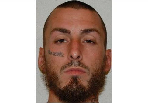 This undated photo provided by the Virginia Sex Offender Registry shows Casey Spain. An ex-convict arrested Thursday, Aug. 31, 2017, on a gun charge became a supporter of the Islamic state group radicalized during his incarceration and wanted to join the organization overseas, according to an FBI affidavit. Casey Spain's support of the Islamic State group was such that he had the ISIS flag tattooed on his back, to go along with the "Cop Killa" tattoo he already had on his right cheek, according to the affidavit from FBI agent Heather Brown. (Virginia Sex Offender Registry via AP)