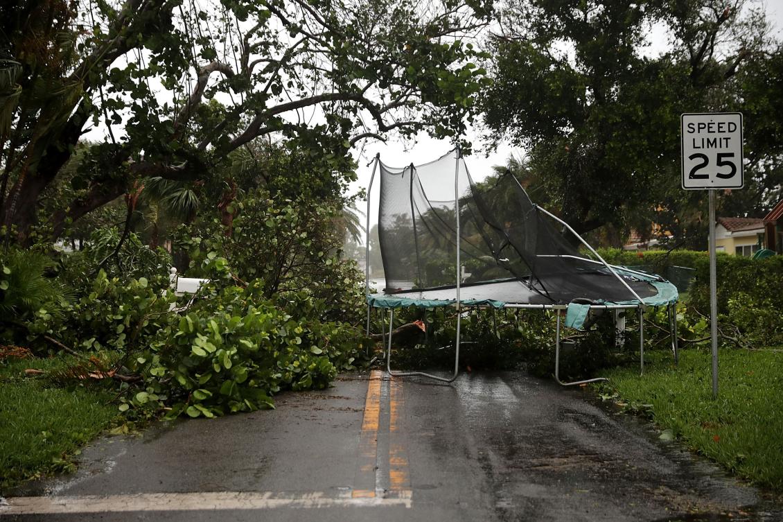 POMPANO BEACH, FL - SEPTEMBER 10: Downed trees and a windblown trampoline block a street as Hurricane Irma hits the southern part of the state September 10, 2017 in Pompano Beach, Florida. The Category 4 hurricane made landfall in the United States in the Florida Keys at 9:10 a.m. after raking across the north coast of Cuba. Chip Somodevilla/Getty Images/AFP == FOR NEWSPAPERS, INTERNET, TELCOS & TELEVISION USE ONLY ==