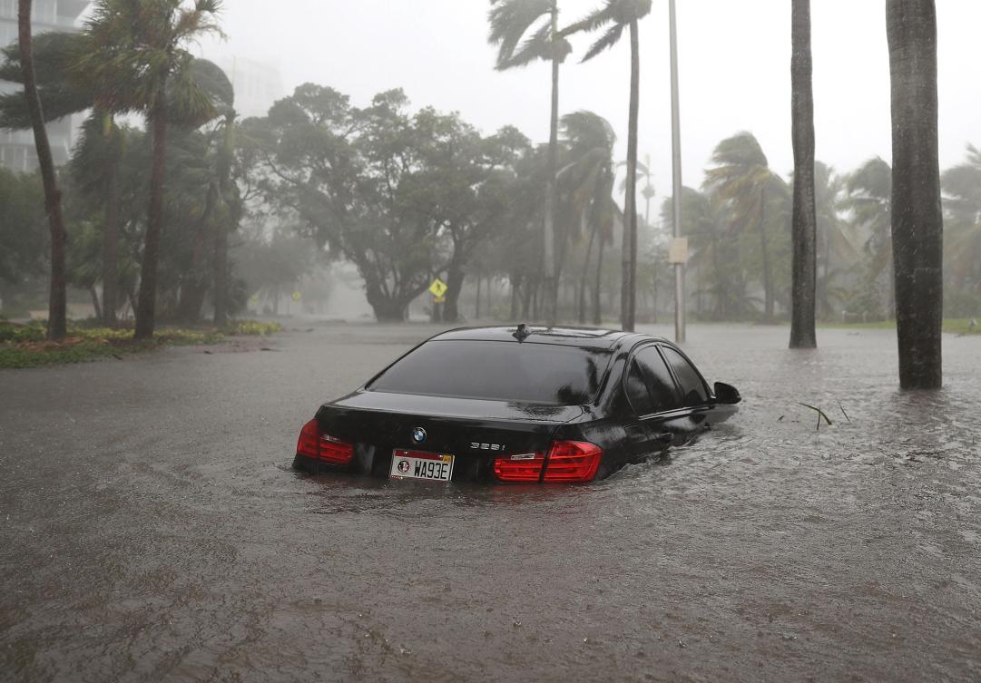 MIAMI, FL - SEPTEMBER 10: A car is seen in a flooded street as Hurricane Irma passes through on September 10, 2017 in Miami, Florida. Hurricane Irma made landfall in the Florida Keys as a Category 4 storm on Sunday, lashing the state with 130 mph winds as it moves up the coast. Joe Raedle/Getty Images/AFP == FOR NEWSPAPERS, INTERNET, TELCOS & TELEVISION USE ONLY ==