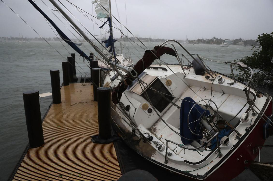 MIAMI, FL - SEPTEMBER 10: A boat is tipped at an angle along the dock at the Watson Island marina as Hurricane Irma passed through the area on September 10, 2017 in Miami, Florida. Florida is taking a direct hit by the Hurricane which made landfall in the Florida Keys as a Category 4 storm on Sunday, lashing the state with 130 mph winds as it moves up the coast. Joe Raedle/Getty Images/AFP == FOR NEWSPAPERS, INTERNET, TELCOS & TELEVISION USE ONLY ==