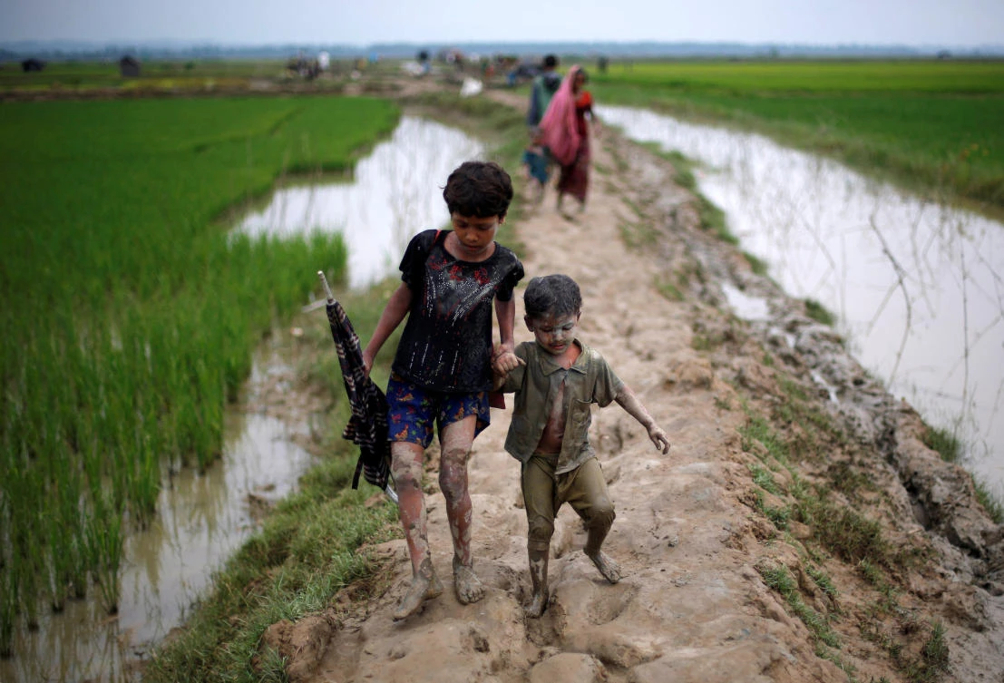 Rohingya refugee children walk on a muddy path after crossing the Bangladesh-Myanmar border, in Teknaf, Bangladesh, September 6, 2017. REUTERS/Danish Siddiqui