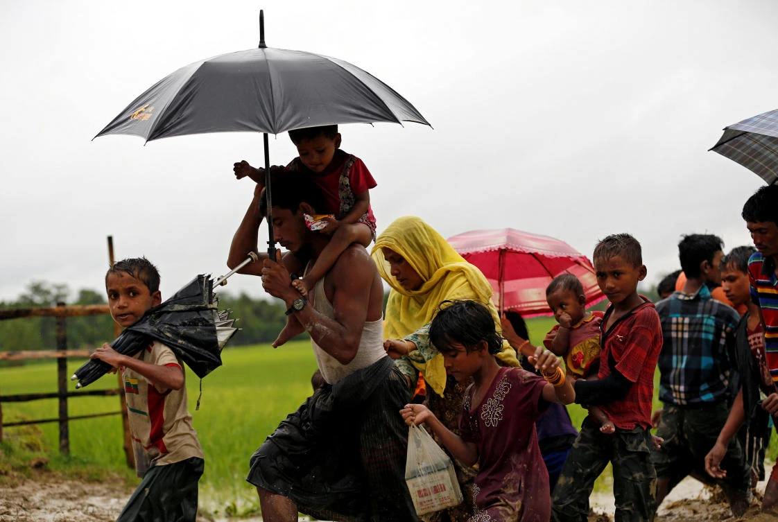 Rohingya refugees walk on the muddy path after crossing the Bangladesh-Myanmar border in Teknaf, Bangladesh September 1, 2017. Picture taken September 1, 2017. REUTERS/Mohammad Ponir Hossain