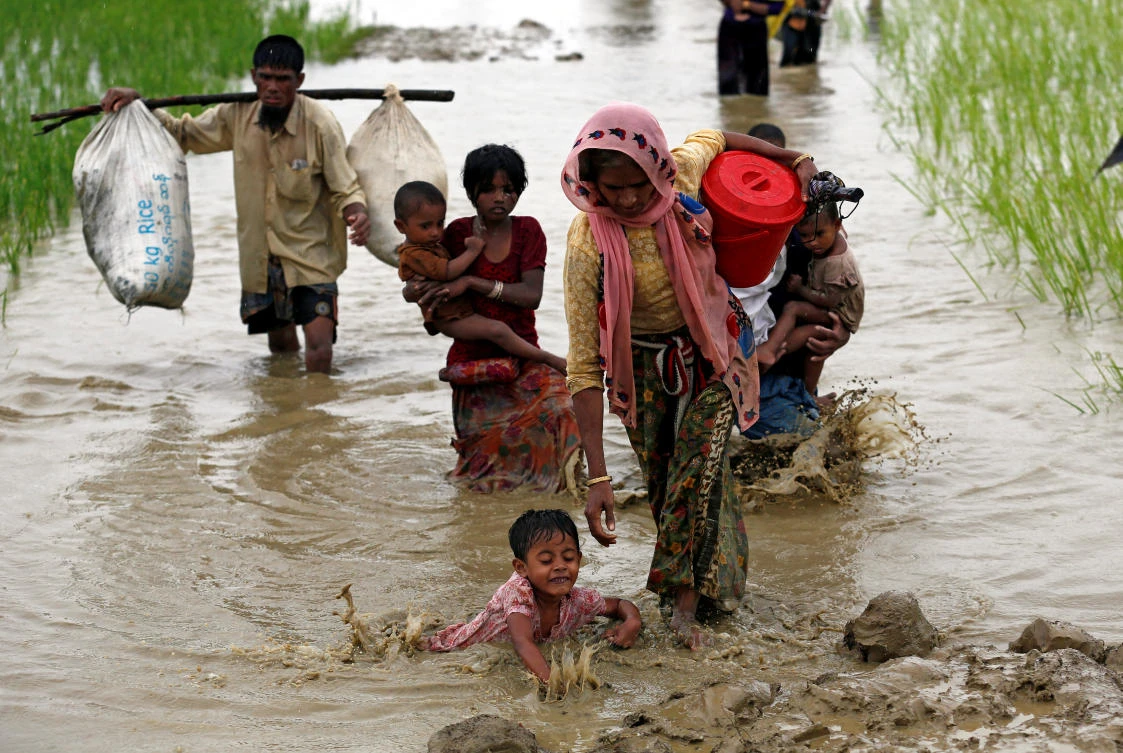 A Rohingya refugee child falls as she walks through the water after crossing the border, in Teknaf, Bangladesh September 1, 2017. Picture taken September 1, 2017. REUTERS/Mohammad Ponir Hossain