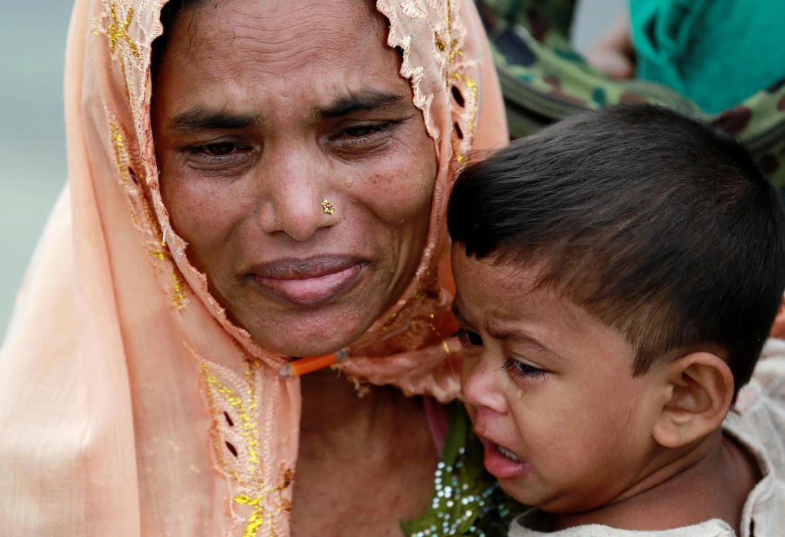 Rohingya refugees cry as they sit on the shore after crossing the Bangladesh-Myanmar border by boat through the Bay of Bengal in Teknaf, Bangladesh September 7, 2017. REUTERS/Danish Siddiqui