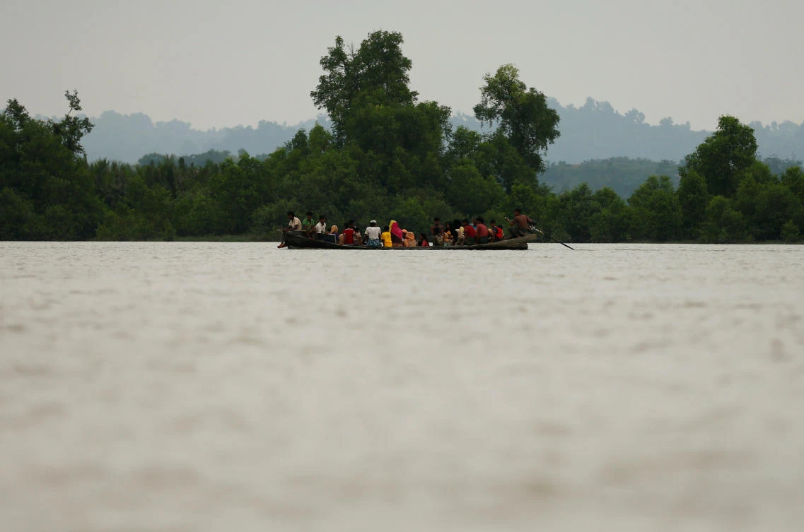 Rohingya refugees are seen on a boat as they are crossing border through the Naf river in Teknaf, Bangladesh, September 7, 2017. REUTERS/Mohammad Ponir Hossain