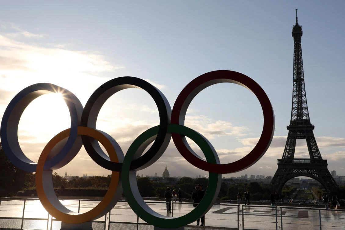 People take pictures of the Olympic rings installed on the Esplanade du Trocadero near the Eiffel tower following the Paris' nomination as host for the 2024 Olympics, on September 14, 2017 in Paris. / AFP / LUDOVIC MARIN