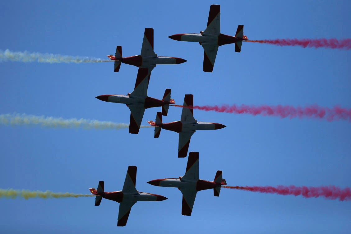 Casa C-101 Aviojets from the Spanish Air Force aerobatic group Patrulla Aguila (Eagle Patrol) fly during an international aerial and naval military exhibition commemorating the centennial of the Spanish Naval Aviation, over a beach near the naval airbase in Rota, southern Spain, September 16, 2017. REUTERS/Jon Nazca