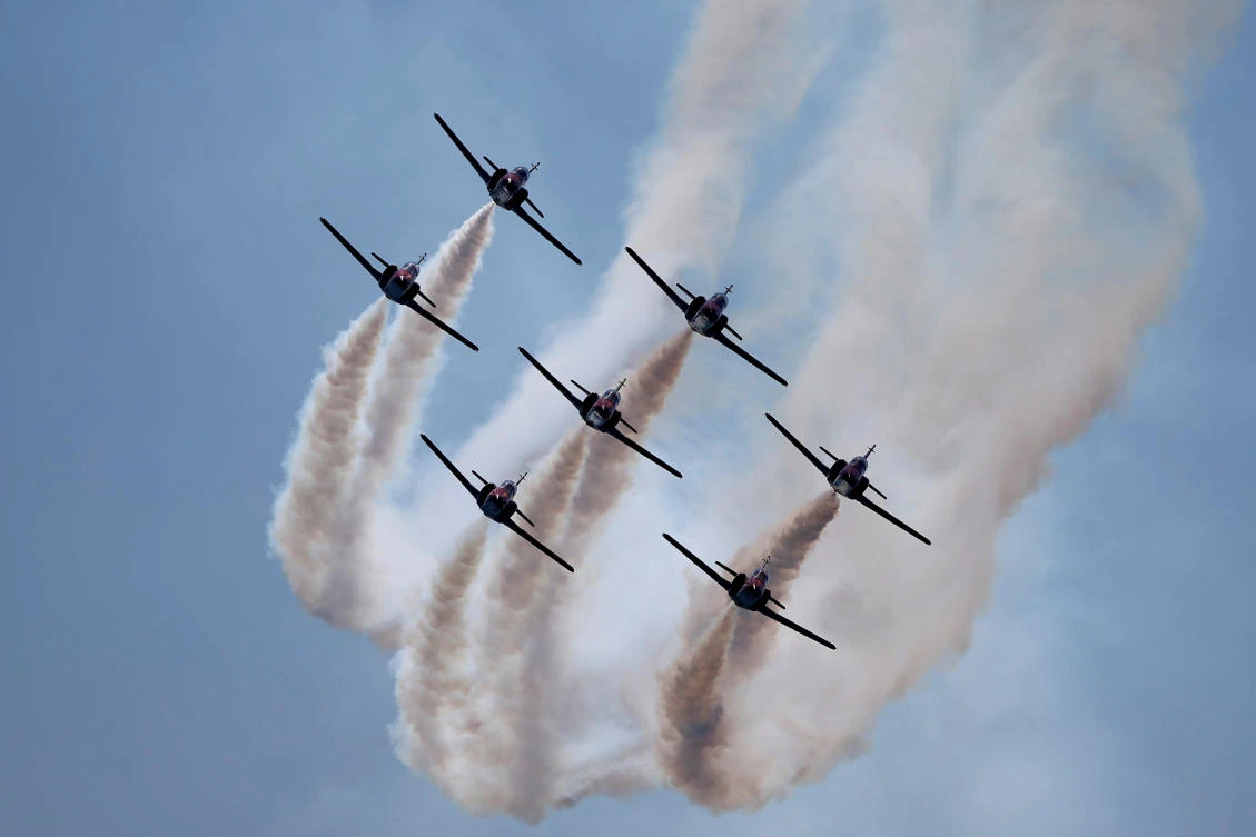 Casa C-101 Aviojets from the Spanish Air Force aerobatic group Patrulla Aguila (Eagle Patrol) fly during an international aerial and naval military exhibition commemorating the centennial of the Spanish Naval Aviation, over a beach near the naval airbase in Rota, southern Spain, September 16, 2017. REUTERS/Jon Nazca