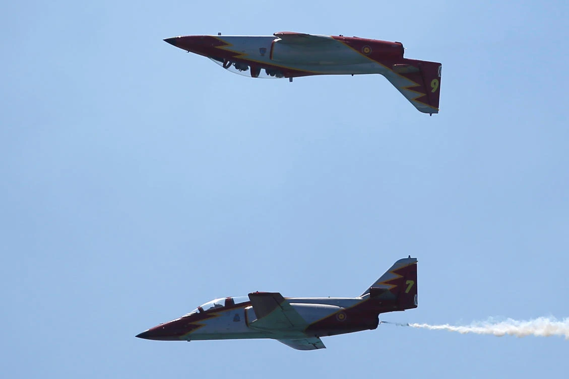 Casa C-101 Aviojets from the Spanish Air Force aerobatic group Patrulla Aguila (Eagle Patrol) fly during an international aerial and naval military exhibition commemorating the centennial of the Spanish Naval Aviation, over a beach near the naval airbase in Rota, southern Spain, September 16, 2017. REUTERS/Jon Nazca