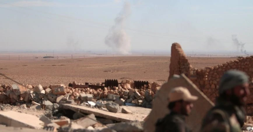 Smoke rises in the background as Syrian Democratic Forces fighters stand near rubble of a destroyed building, north of Raqqa, Syria, November 7, 2016. (Reuters)