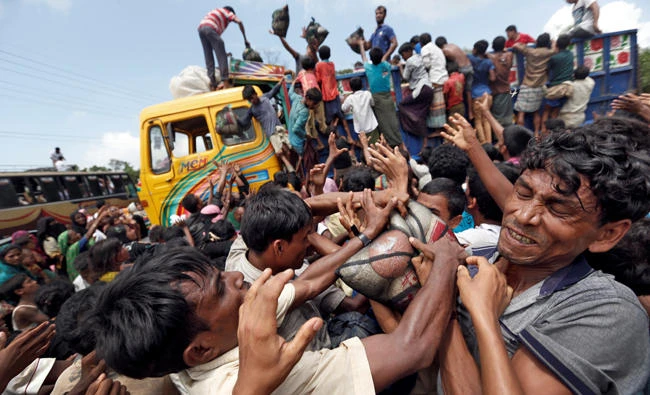 Rohingya refugees scuffle as aid is distributed in Cox's Bazar, Bangladesh, on Saturday. (Reuters)