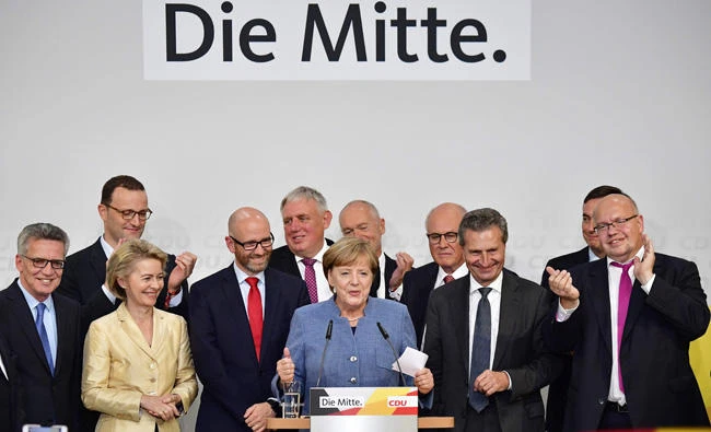 Merkel wins fourth term, hard right gains foothold in parliament